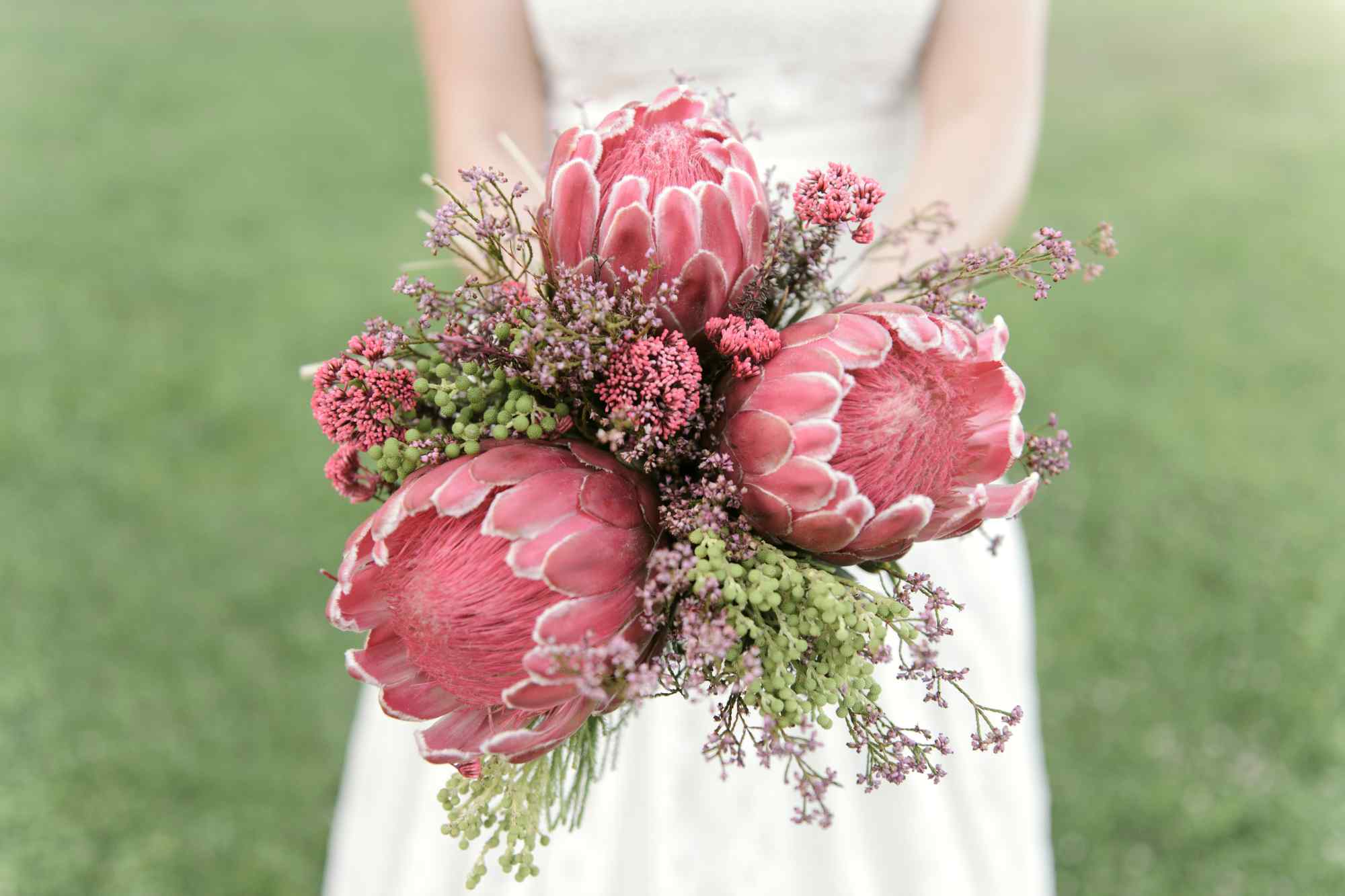 Autumn bridal bouquet that is composed of 3 dried protea repens and eucalyptus